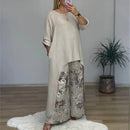 Conjunto Botanique™ com blusa assimétrica longa e calça pantalona floral, estilo artístico e corte impecável, usado por uma modelo.