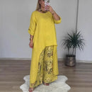 Conjunto Botanique™ com blusa assimétrica longa e calça pantalona floral, estilo artístico e corte impecável, em tom vibrante.
