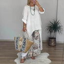 Conjunto Botanique™ com blusa assimétrica longa e calça pantalona floral, estilo artístico, corte impecável, moda feminina moderna.
