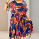 Vestido midi Tropicália™ estampado com sobreposição, da ModernLar, mostrado em close em tecido leve e cores vibrantes.