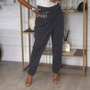 Calça Calista™ com design assimétrico, cinto exclusivo da ModernLar, vestida na modelo, detalhe de costura e tecido elegante